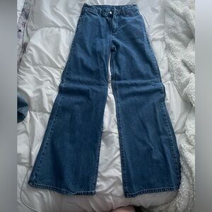 Medium wash high rise baggy jeans with no back pockets. SHEIN; size 29x32